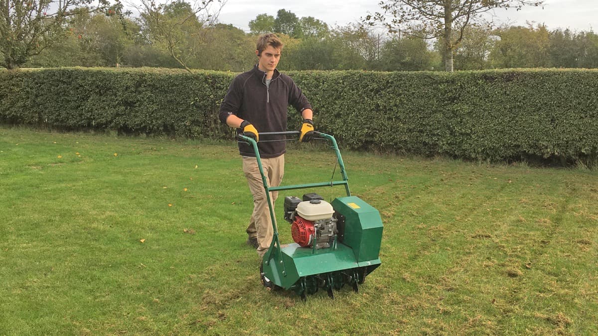 George aerating a lawn with a hollow-tine aerator